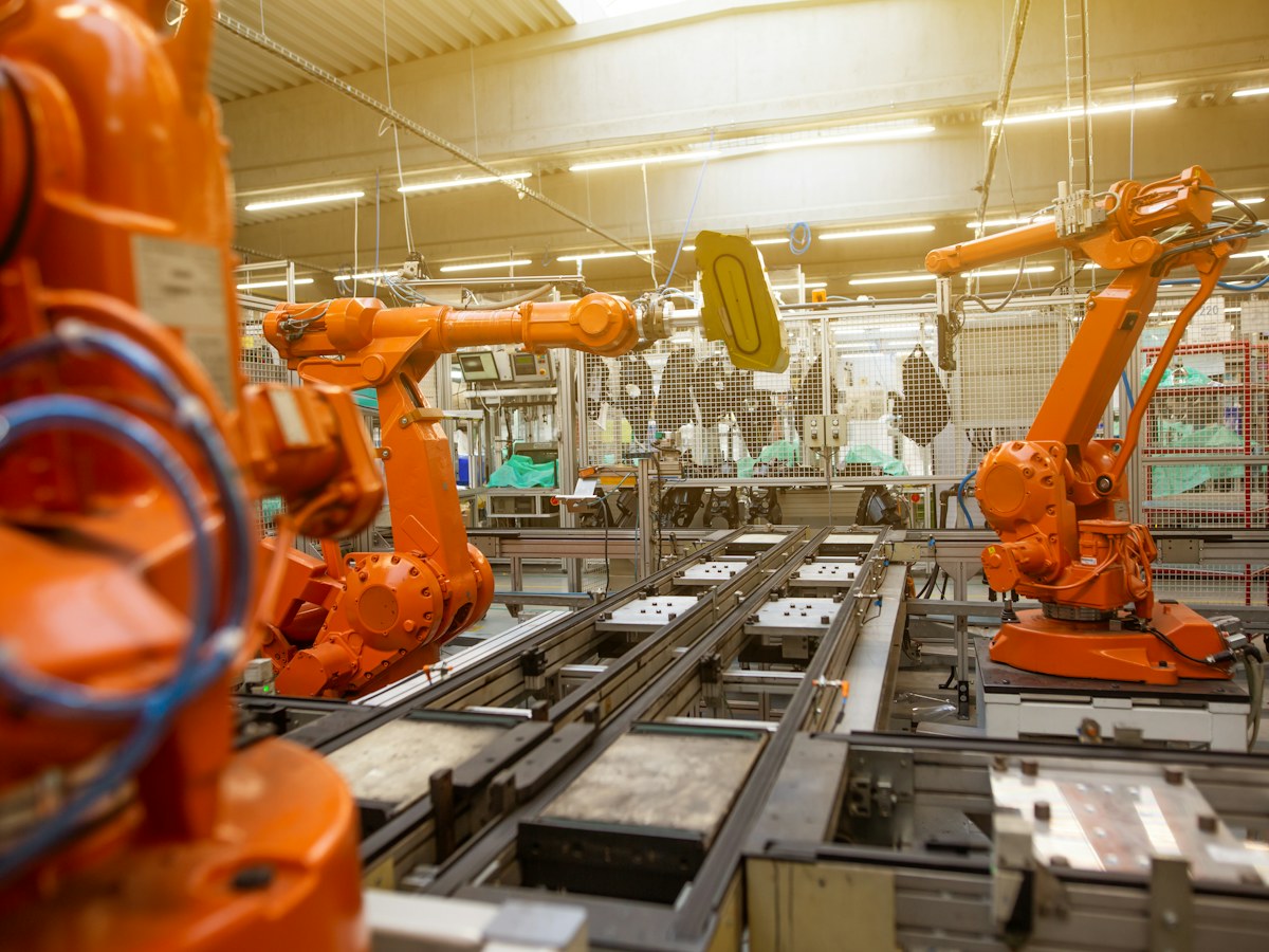 Industrial robot arms on a factory production line